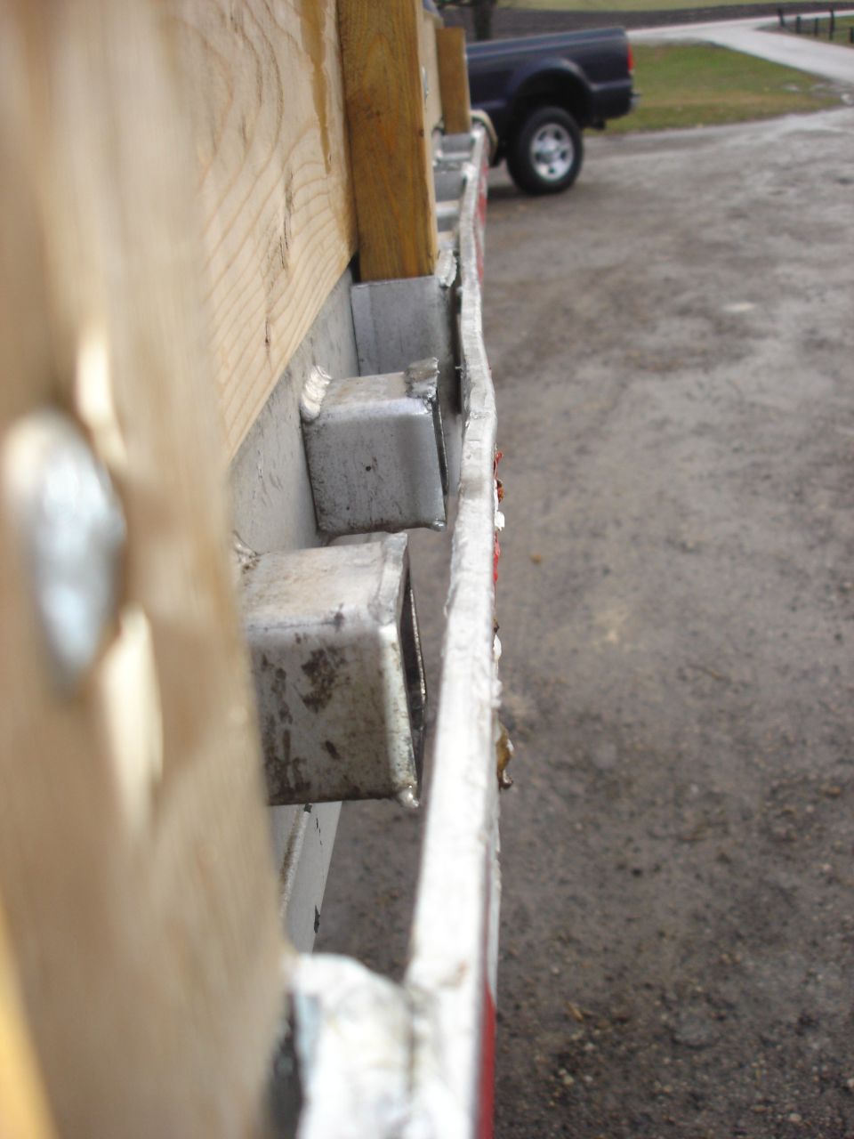 2006 Ford F-350 truck bed side rail with wooden planks and metal supports