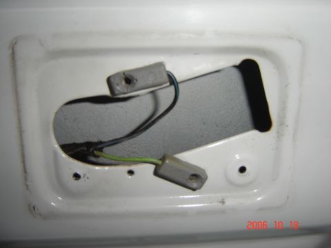 1993 Ford Bronco - Close-up of electrical wiring and connectors within a white housing, likely for a vehicle light.