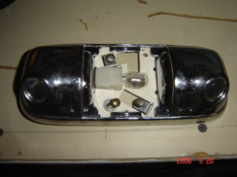 1993 Ford Bronco - Dome light assembly removed from vehicle, showing internal components and bulb.