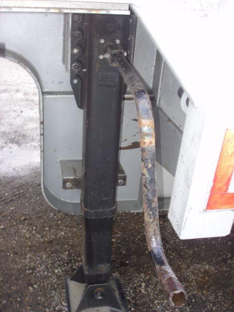 2006 Ford F-350 - Close-up of a trailer's landing gear mechanism, showing the crank and support structure.