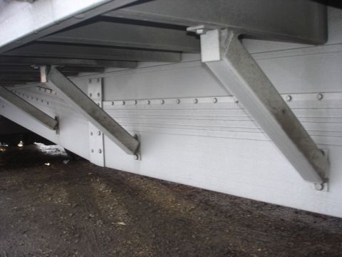 2006 Ford F-350 - The underside of a trailer shows its structural supports and ribbed metal siding.