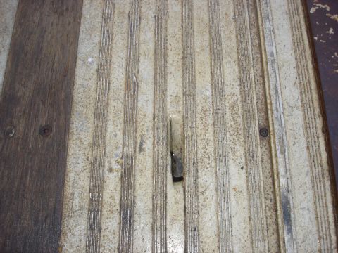 2006 Ford F-350 - Close-up of a worn truck bed floor, a mix of wood and ribbed metal surfaces.