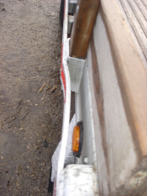 2006 Ford F-350 - Trailer side marker light assembly with metal bracing visible.