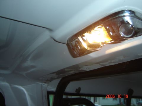 1993 Ford Bronco - Close-up of a vehicle's interior dome light, showing the bulb and housing.