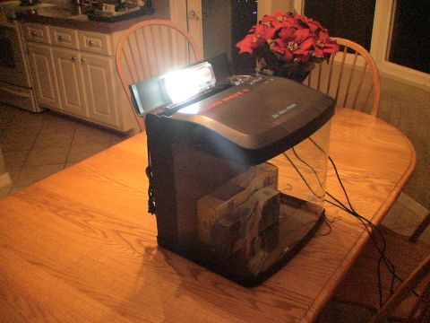 1993 Ford C-350 (Centurion Conversions) - An aquarium setup with a light fixture and artificial plants sits on a wooden dining table.