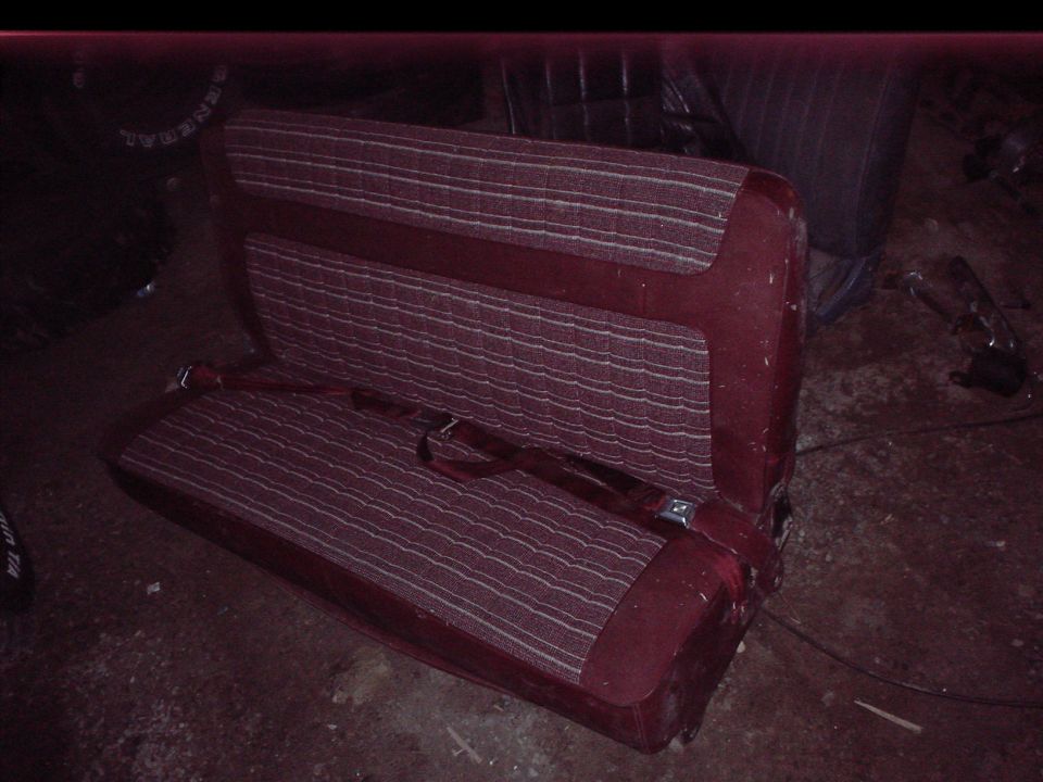 Maroon car seat with striped fabric and seatbelt