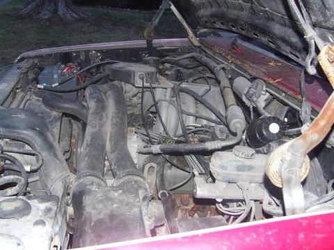 1992 Ford Bronco - The engine bay of a vehicle is shown, with the hood open. A Supermotors.net logo is visible in the lower right corner.