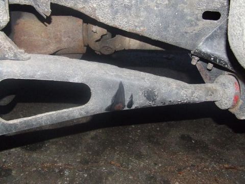 1992 Ford Bronco - A close-up view of a vehicle's suspension system, focusing on a control arm and associated parts.