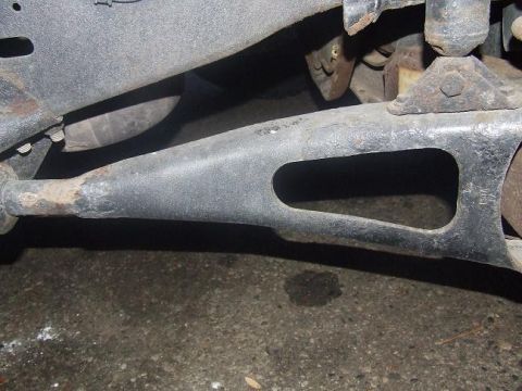 1992 Ford Bronco - A close-up view of a vehicle's suspension component, showing rust and wear.