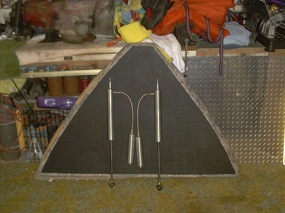 Two shock absorbers and two springs mounted on a triangular board