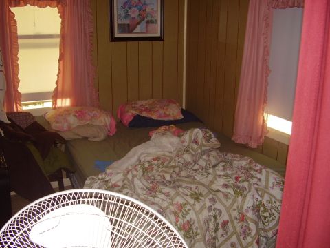 1996 Ford F-150 - Bedroom interior with floral bedding and pink curtains. Supermotors.net logo is present.