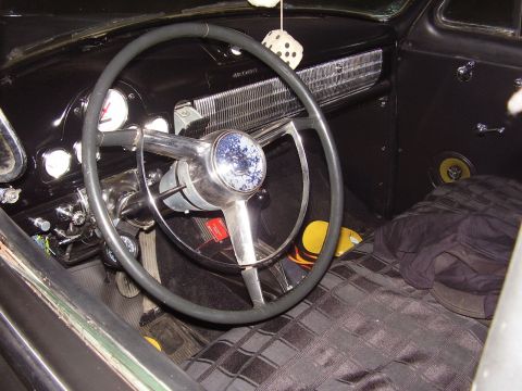 1996 Ford F-150 - The interior of a classic vehicle is shown, a prominent steering wheel and dashboard details.