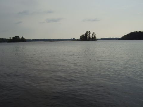 1996 Ford F-150 - Calm lake waters with islands dotting the horizon under an overcast sky.