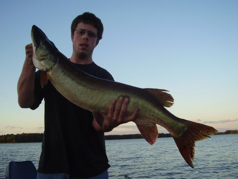 1996 Ford F-150 - A man proudly displays a large fish he caught while out on the water.