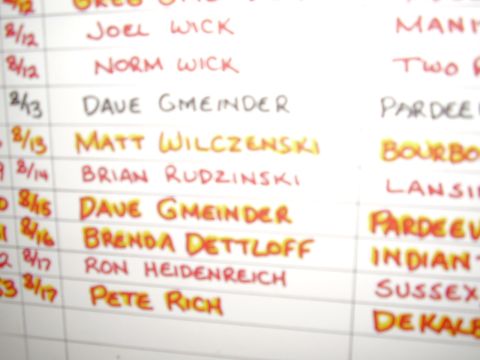 1996 Ford F-150 - A whiteboard displays handwritten names and dates, possibly a registration or entry list.