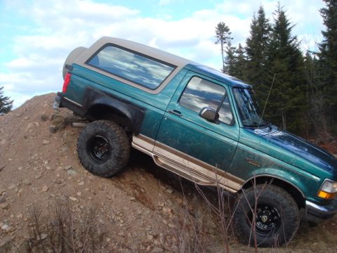1996 Ford Bronco - This 1996 Ford Bronco is shown navigating a steep, rocky incline on a cloudy day.