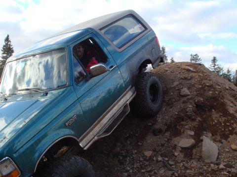 1996 Ford Bronco - This 1996 Ford Bronco is navigating an off-road obstacle on a dirt mound.