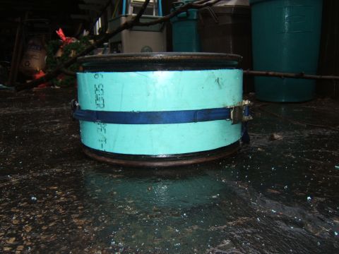 1980 Jeep CJ5 - A close-up shows a vehicle wheel rim with a blue strap around a light blue cylindrical object.