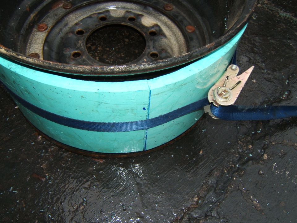 Wheel rim with teal padding secured by a blue strap