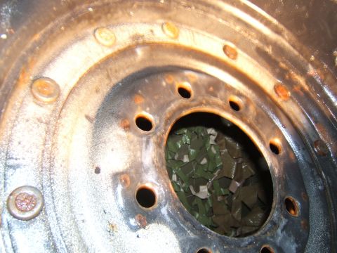 1980 Jeep CJ5 - Close-up of a heavily rusted wheel rim, showing the lug nut holes and inner barrel.