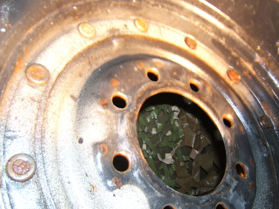 Rusted wheel rim with multiple lug nut holes