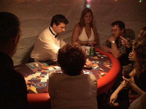 1993 Ford C-350 (Centurion Conversions) - A group of people are gathered around a poker table, engaged in a game with chips and cards visible.