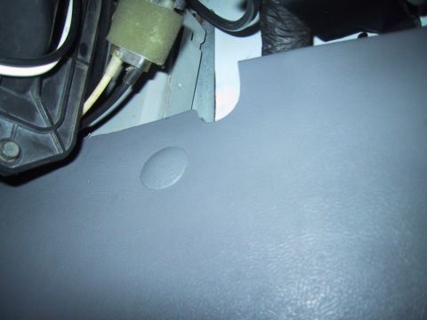 1994 Ford Bronco - Interior car part detail, showing wiring and a gray plastic panel.