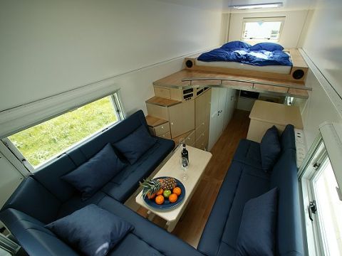 1993 Ford Bronco - Camper van interior features a sleeping loft, ample seating, and a compact dining area.