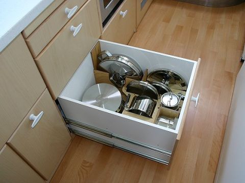 1993 Ford Bronco - A drawer is pulled open, revealing an organized collection of cookware within a kitchen setting.