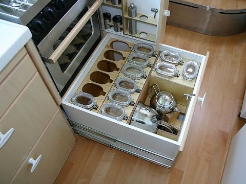 1993 Ford Bronco - Custom RV kitchen drawer features organized spice jars and cookware storage.