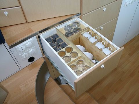 1993 Ford Bronco - Open drawer in an RV cabinet reveals organized storage for glasses and cups.