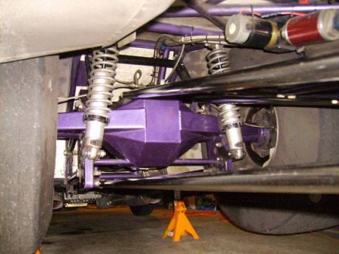1990 Ford Mustang - Close-up view of the rear suspension and differential assembly of a modified vehicle.