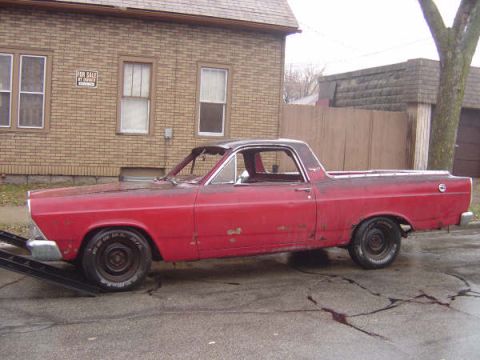1973 Ford Ranchero - This red 1973 Ford Ranchero is positioned on a ramp, showing its side profile.