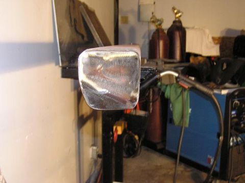 2000 Chevrolet Tahoe - A metal slider bar is shown, likely a vehicle part, in a workshop setting with welding equipment visible.