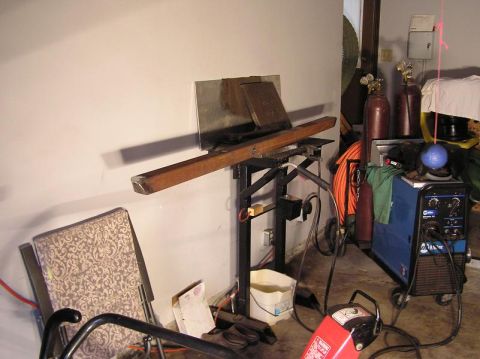 2000 Chevrolet Tahoe - A workshop scene welding equipment, gas cylinders, and a chair, with visible text on the welding machine and a watermark.
