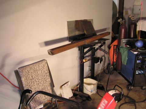 2000 Chevrolet Tahoe - A workshop scene with welding equipment, gas cylinders, and a makeshift workbench is shown.