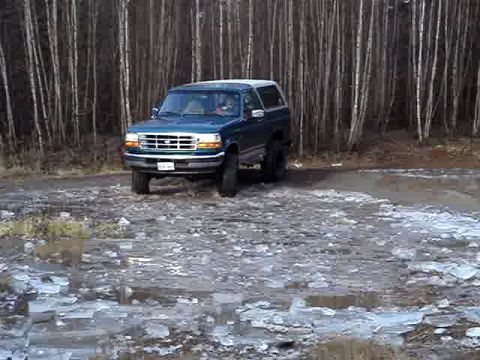 1996 Ford Bronco - This 1996 Ford Bronco is seen from a 3q-front angle in a wooded area with icy ground cover.