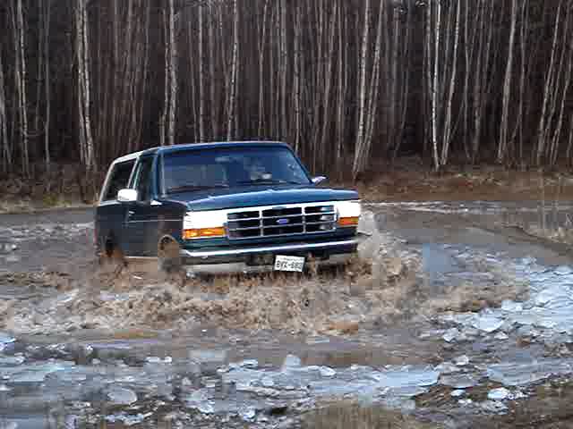 1996 Ford Bronco driving through mud and ice