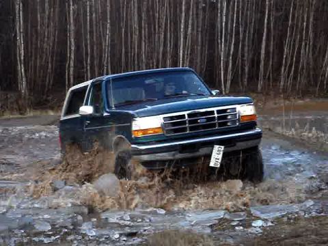 1996 Ford Bronco - This 1996 Ford Bronco navigates through a muddy, watery terrain, kicking up spray.