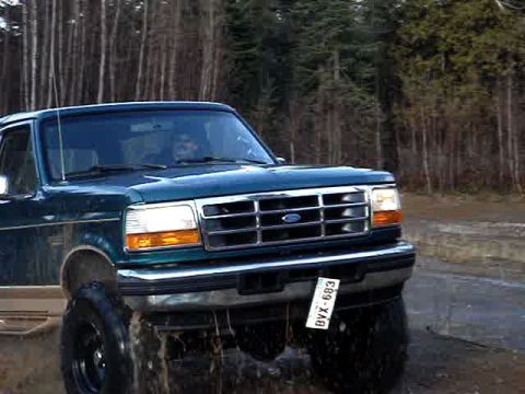 1996 Ford Bronco - This 1996 Ford Bronco is shown off-road with mud splashing.