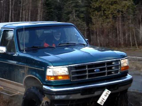 1996 Ford Bronco - This 1996 Ford Bronco is seen from a 3/4 front view, with its distinctive grille and headlights visible.