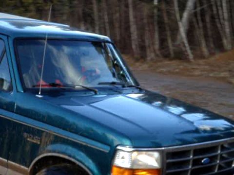 1996 Ford Bronco - This 1996 Ford Bronco is seen in a three-quarter front view, with 'BRONCO' badging clearly visible on the fender.