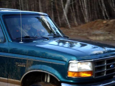 1996 Ford Bronco - Teal 1996 Ford Bronco showing front quarter panel and headlight detail.