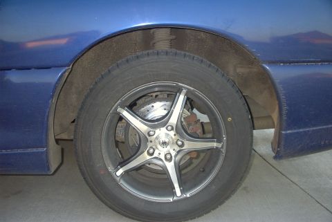 1994 Dodge Stealth - Aftermarket wheels and drilled rotors are visible on the front of this blue vehicle.