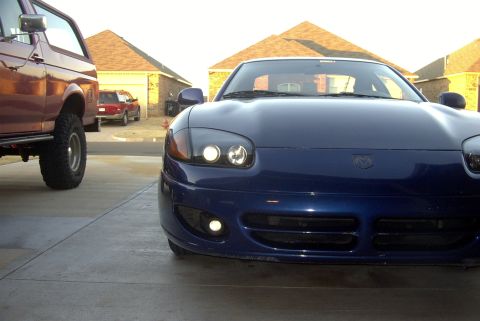 1994 Dodge Stealth - A blue sports car with a distinctive front end is parked in a driveway.