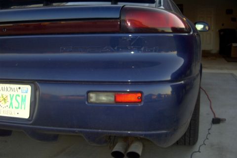 1994 Dodge Stealth - The rear of a blue sports car is shown, dual exhaust pipes and an Oklahoma license plate.