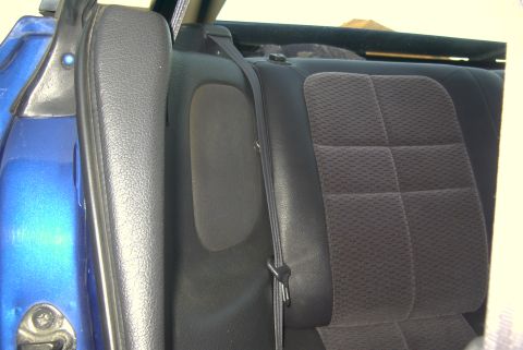 1994 Dodge Stealth - Close-up view of the rear passenger seat and door panel inside a blue vehicle.