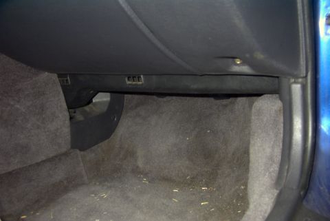 1994 Dodge Stealth - A view of the interior dashboard, focusing on the area beneath the glove compartment.