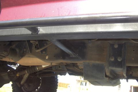 1994 Ford Bronco - Close-up view of the underbody, focusing on the sliders and suspension of a vehicle.