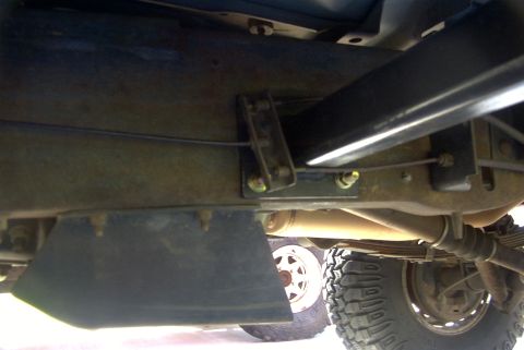 1994 Ford Bronco - Close-up view of the underbody, focusing on the sliders and suspension system of a vehicle.